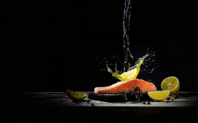 advertisement food photography splash of lemon juice around salmon steak on black background