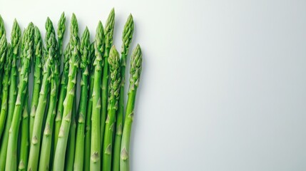 Fototapeta premium Fresh green asparagus spears on white background.