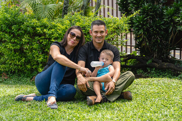 Photo of son with Down syndrome next to his parents sitting in the yard
