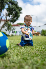 Photo of child with Down syndrome looking at his toy ball