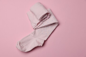 Beautiful child's tights on pink background, top view