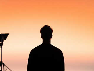 silhouette of a person against a vibrant sunset sky