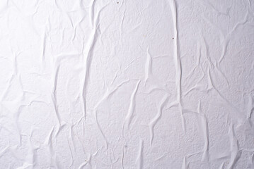 white crumpled and creased glued wrinkled paper poster texture background