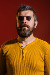Obraz premium Blind man. Visually impaired. Despite disability. Bearded blind man wearing glasses, studio portrait. Blinded people concept. Disability and blind. Blind mature man.