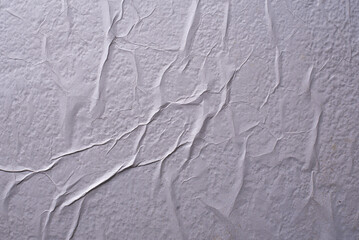 white crumpled and creased glued wrinkled paper poster texture background