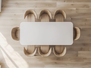 Top view of a white rectangular dining table with six wooden chairs set around it in a light-filled modern interior.
