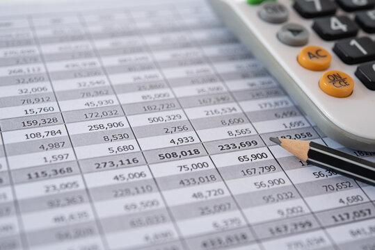 accounting bookkeeping business concept. balance sheet and account audit report with calculator on accountant desk.