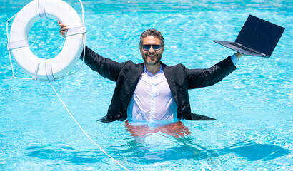 Rescue business. Business man in suit hold laptop and rescue lifebuoy in swim pool. Rescue swimming...