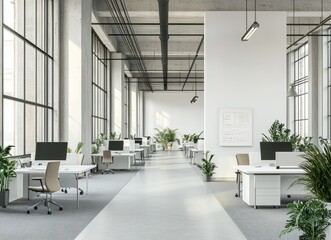 A modern, open-plan office space with large windows, white walls, and grey carpet. There are rows of desks with computers and plants. The space is bright and airy, with natural light streaming in.