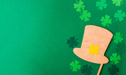 Green background with a shamrock and a hat on it