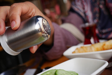 Salt falls from a salt shaker 