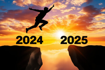 Silhouette of a Man jumps from 2024 to 2025 against a vibrant sunset sky and hill. move to new year celebration concept.