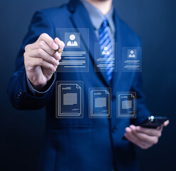 Businessman working with laptop computer with document management icons on virtual screen. Technology concept of data transfer, file recovery, computer backup, transfer of documents of data folder.