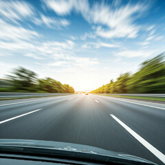 Cars pass in a blur on an empty asphalt highway, captured by the car's front-facing camera as it travels.