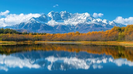 Fototapeta premium A serene landscape featuring snow-capped mountains reflected in a calm lake surrounded by autumn foliage.