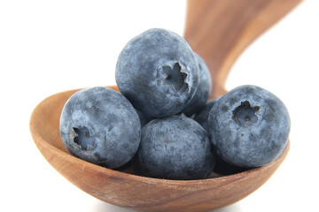 Close-Up of Fresh Blueberries in a Wooden Spoon Isolated on White Background