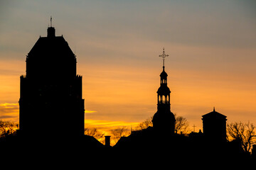 Silhouette of the The Notre-Dame de Québec Basilica-Cathedral church steeple and Édifice Price building among the skyline of Quebec City, Quebec, Canada.