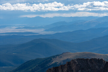 A breathtaking view of layered mountain ranges under a vibrant sky showcasing the beauty of natural landscapes in Colorado