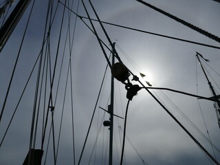 Sailboat mast rigging with eerie sky and sundog