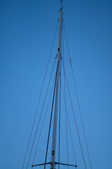 Black and White mast of a Ship Against Blue Sky.