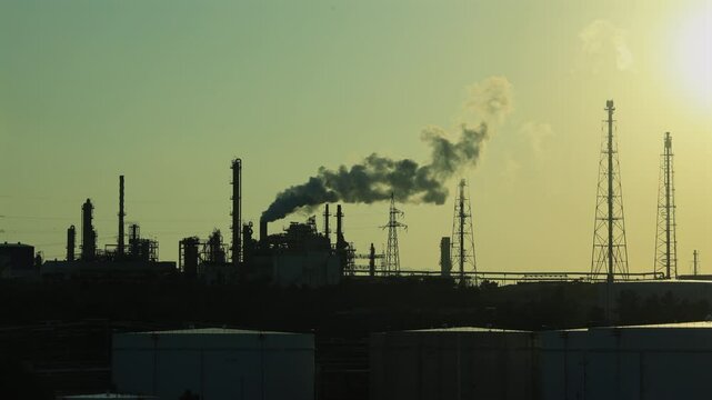 Industrial Skyline with Emissions at Sunset