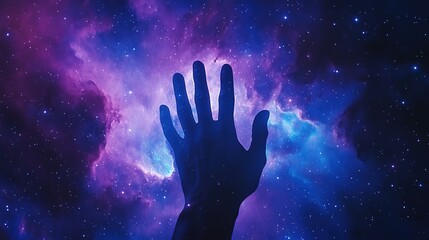 Silhouette of a hand reaching towards a vibrant nebula in space.