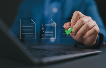 Document management concept, project approve. Businessman using laptop to paperless online approval...