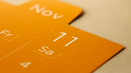 Closeup view of a Calendar Page Highlighting November 11, which falls on a Saturday