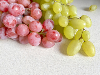 Red and green grapes on the table. Green grape berries. Pink grapes.