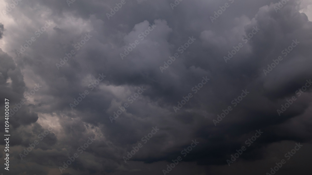 Wall mural dark sky with stormy clouds. dramatic sky rain,dark clouds before a thunder-storm.