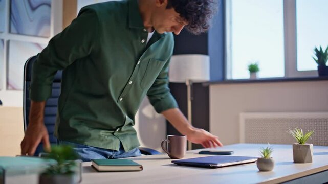 Business manager start workday sit down modern desk closeup. Confident worker 
