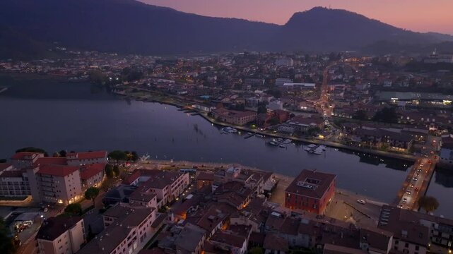 filming over the town of Sarnico, Bergamo, and Paratico Brescia on Lake Iseo at sunset. In the background the Orobic pre-Alps