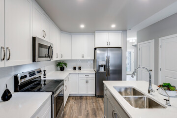 A kitchen with a white stove, microwave, and refrigerator