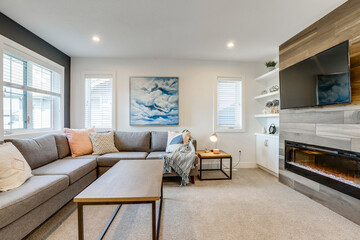 A living room with a couch, a coffee table, and a fireplace