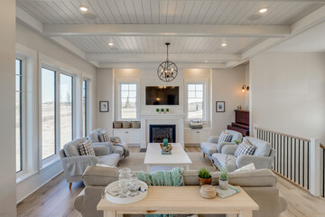 A large living room with a fireplace and a piano