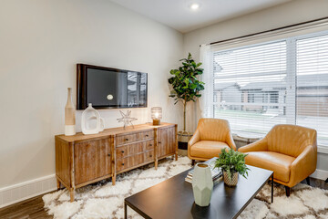 A living room with a brown wooden entertainment center, a television