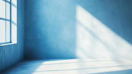 Obraz premium Bright sunlight casting shadows in a minimalistic blue room interior during daytime