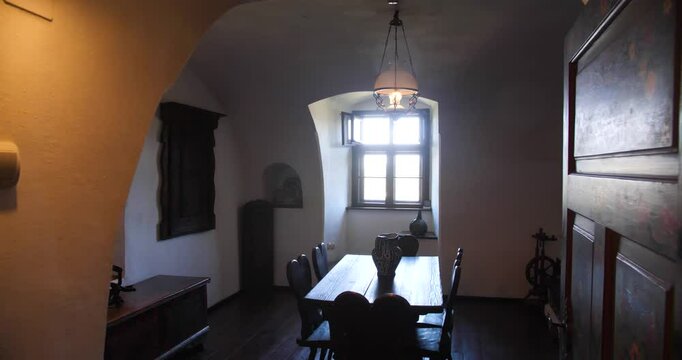 Warm sunlight coming through the window of the vintage style room inside Bran Castle.
