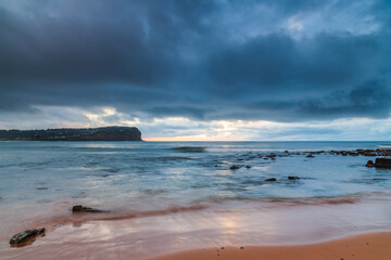 Cloud covered sunrise at the seaside