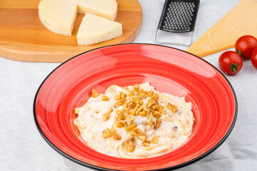 Italian pasta with Parmesan Cheese Sauce. Handmade pasta with parmesan cheese, served with walnuts on top.