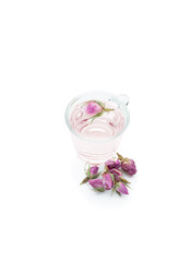 Rose buds tea in a small cup isolated on white