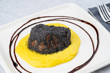 Portion of tenderloin meat. Oven-baked, juicy and delicious tenderloin meat coated with poppy seeds. Served with mashed potatoes.
