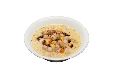 Yuvalama Soup from traditional Turkish cuisine isolated on white background. Yogurt, lamb, chickpeas and manti cooked and served with mint oil.