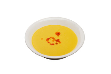 Lentil Soup from traditional Turkish cuisine. Isolated on a white background. Made with red lentils and served with sauce.