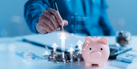 Saving Money: A Person Writes with a Piggy Bank and Calculator on a White Table