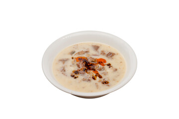 Tripe soup, typical of Turkish cuisine, is served in a bowl isolated on a white background.