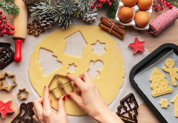 Pastry chef making christmas cookies using dough cutters