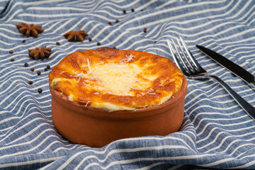 A dish served in a bowl with bechamel sauce and kashar cheese. A delicious oven dish.
