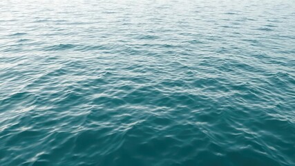 Obraz premium Ripple patterns on calm ocean surface creating a soothing texture, motion
