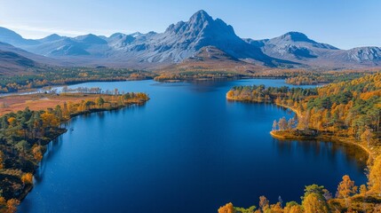 Fototapeta premium Aerial view of a mountain lake surrounded by fall foliage and a mountain peak. AI generative. .
